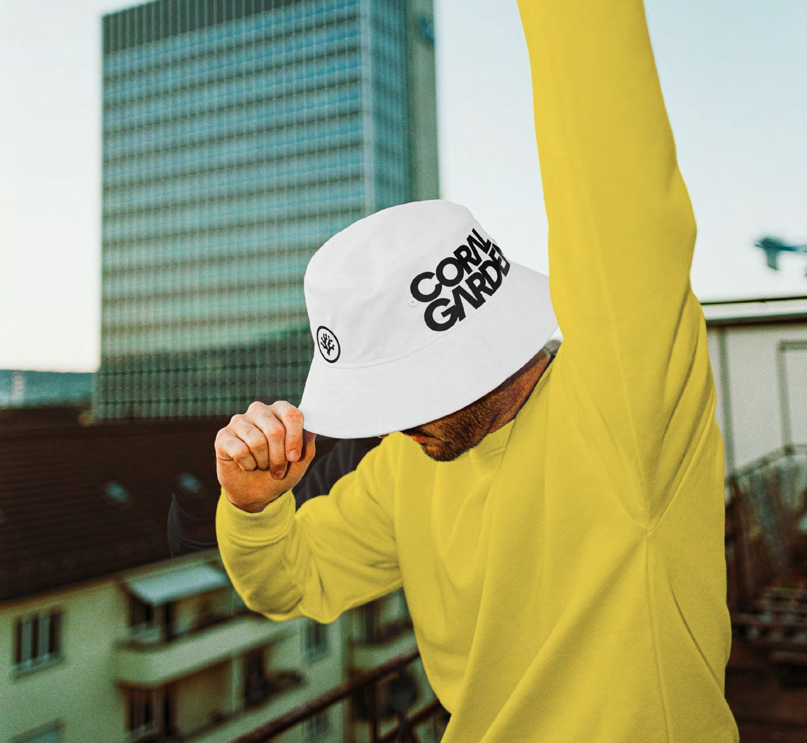 A white bucket hat with the Coral Gardeners wordmark