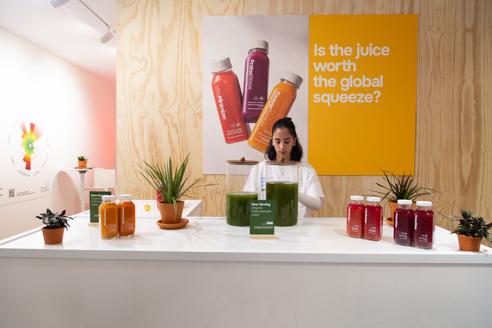 The juice bar counter under a poster asking Is the juice worth the global squeeze?